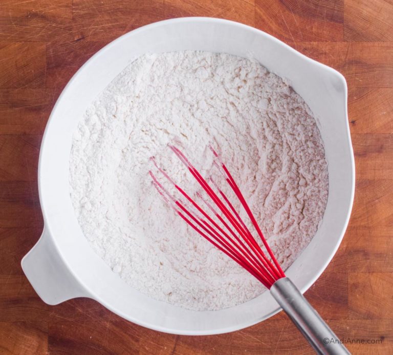 white bowl with flour and red whisk