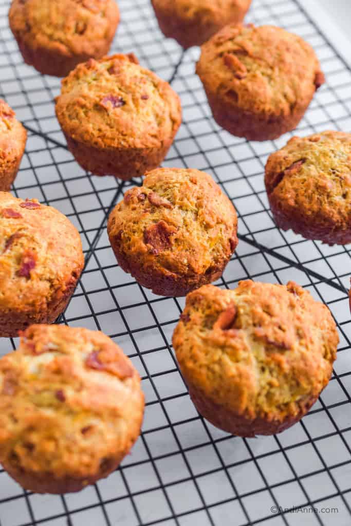 bacon cheese muffin biscuits on a black cooling rack