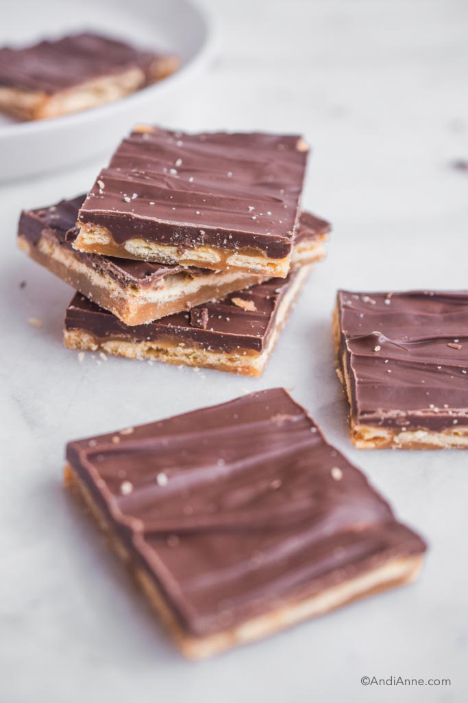 saltine toffee candy stacked on a marble counter.