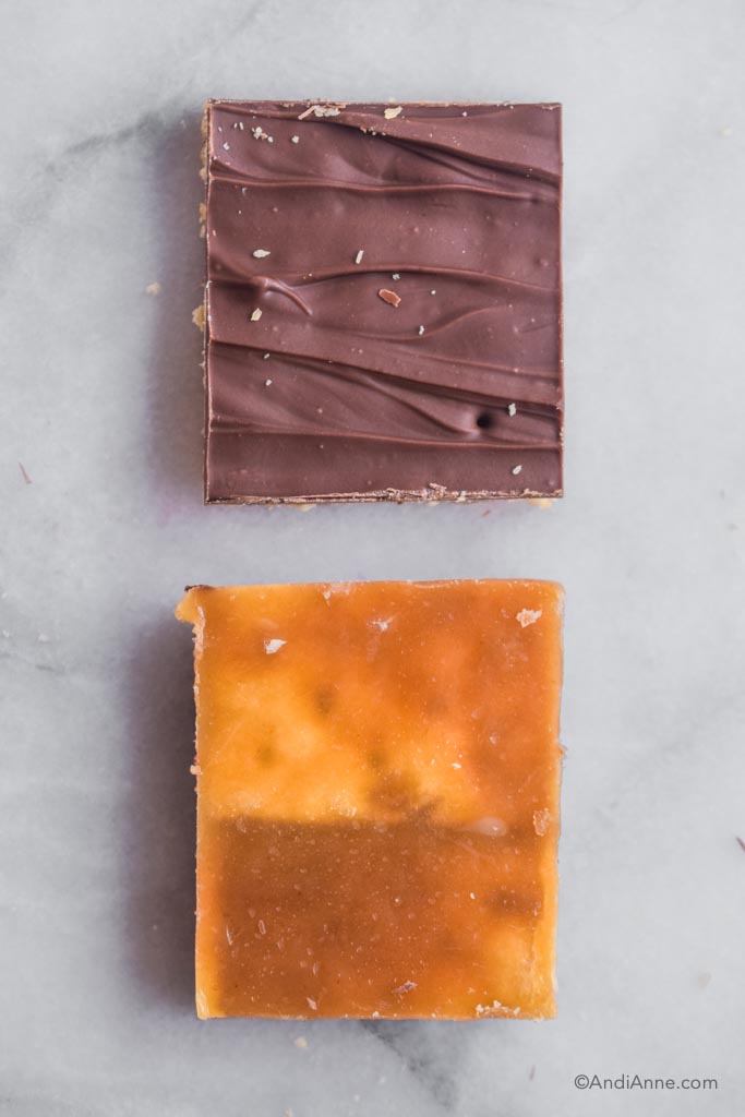 Two pieces of cracker candy. Once showing chocolate side, the other showing the toffee side.