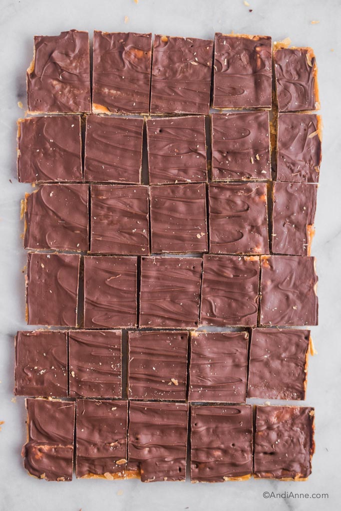 saltine toffee cracker candy sliced into square pieces in a single layer.