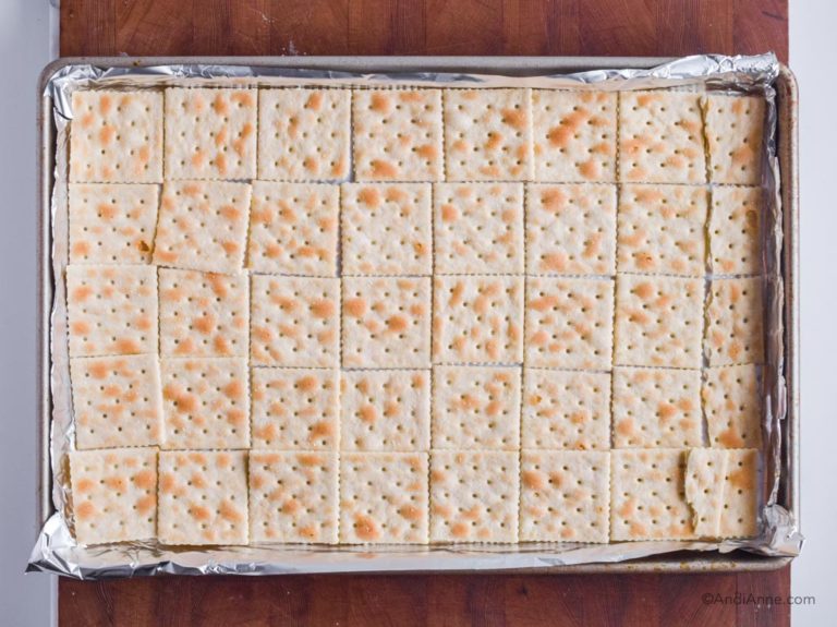 saltine crackers in a single layer inside baking sheet.