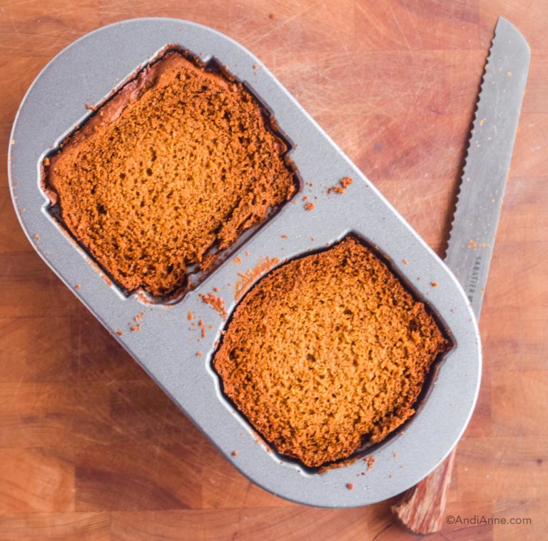 tops sliced off of cake in gingerbread duet pan with bread knife beside it