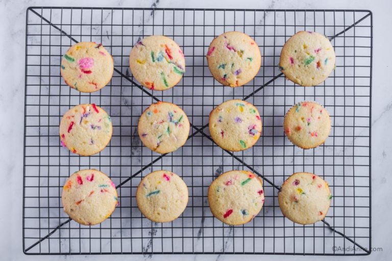 baked confetti cupcakes on a baking rack