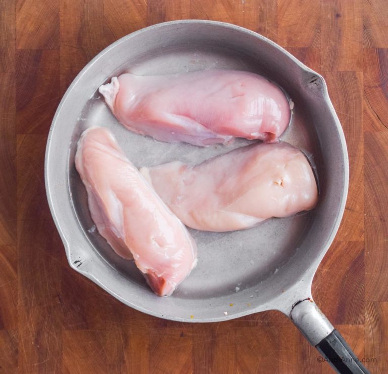 raw chicken in a frying pan