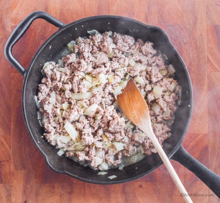ground turkey in frying pan with wood spatula