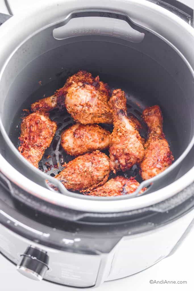Looking into air fryer with crispy parmesan drumsticks