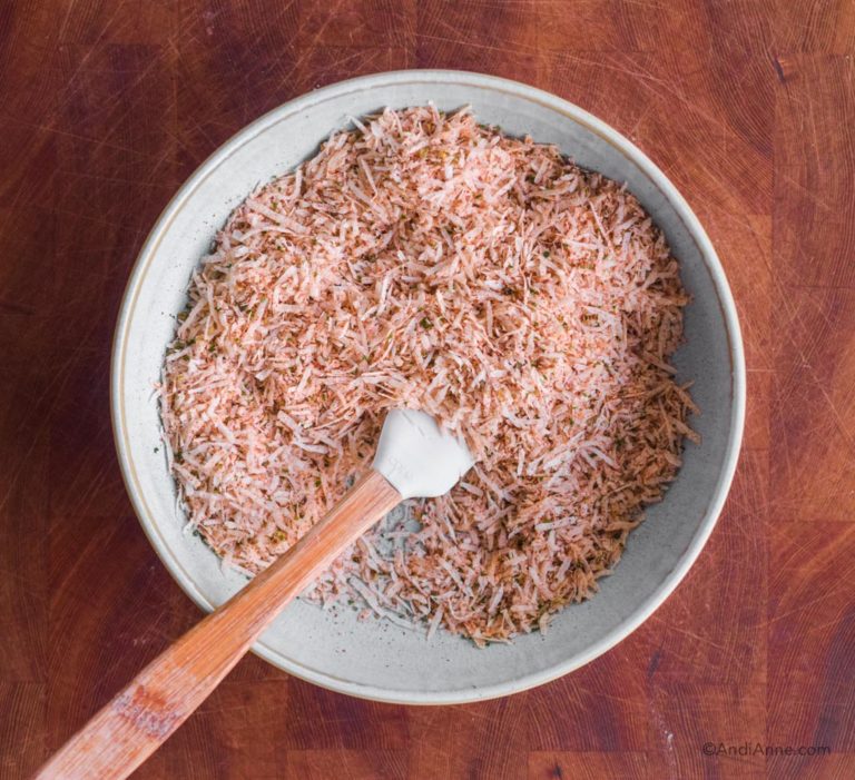 bowl with small spatula and grated parmesan and spices