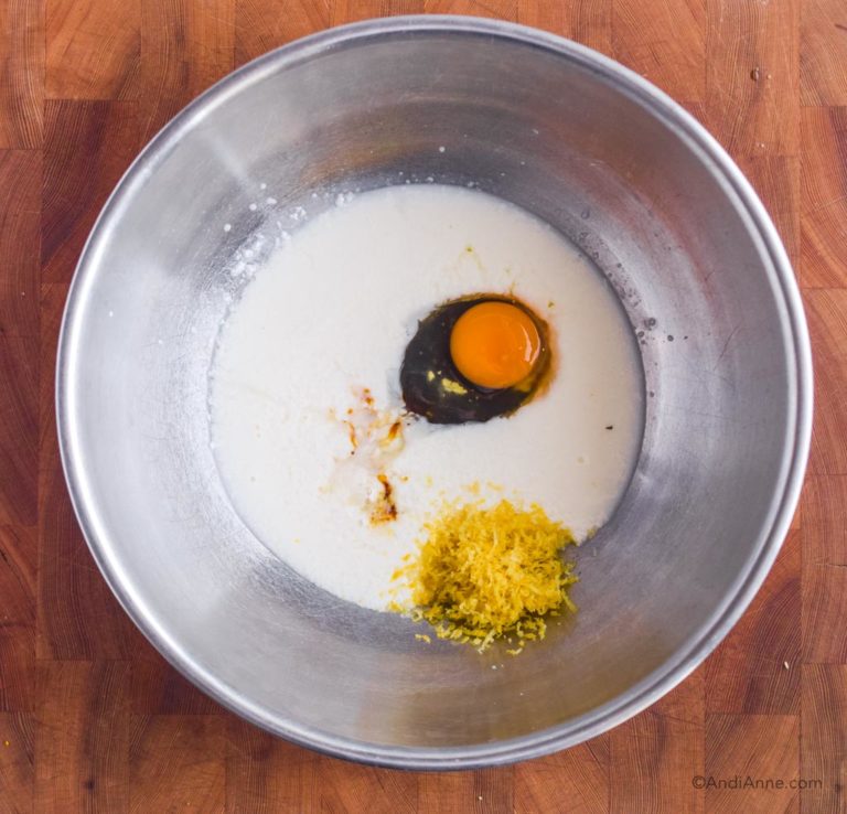 steel bowl with milk mixture, egg and lemon rind