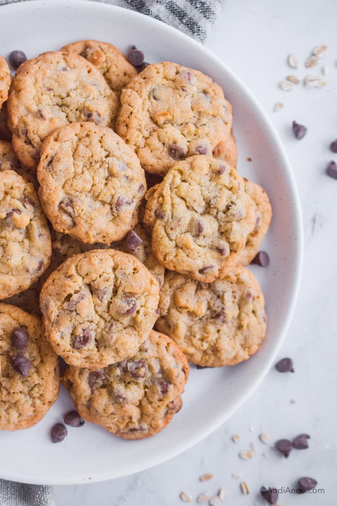 white plate piled with chocolate chip oat cookies
