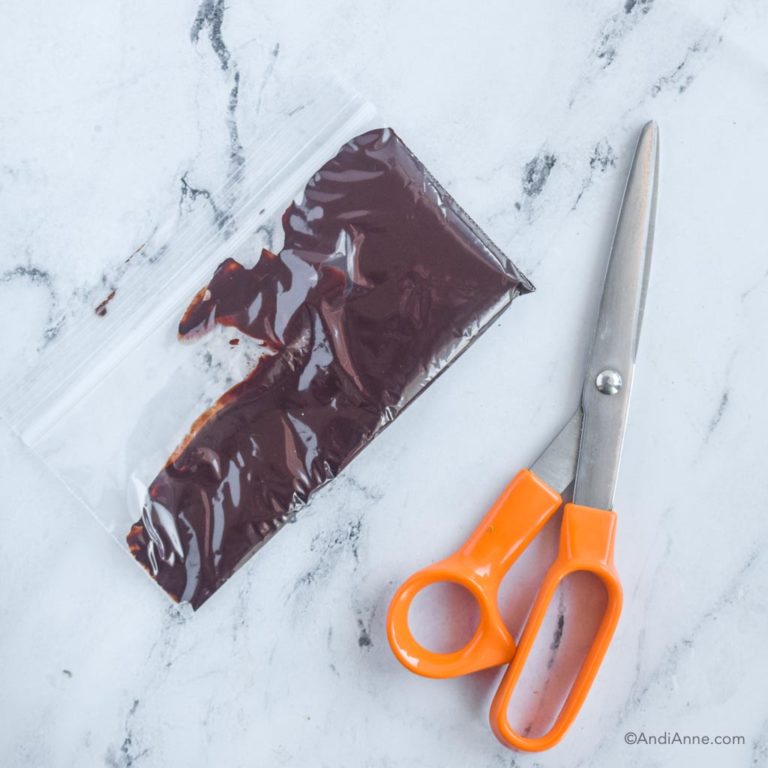 small bag with melted chocolate beside and a pair of scissors