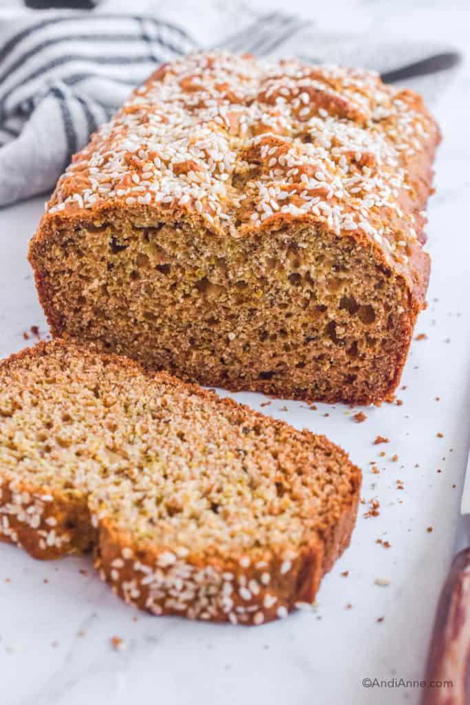 herbed quick bread on white counter with slice cut off