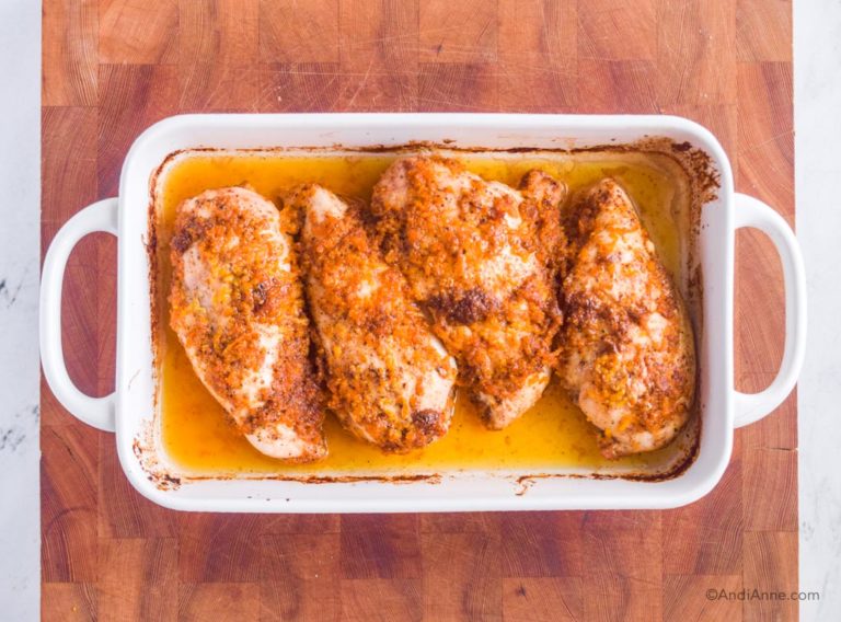 baked orange ginger chicken breasts in white baking dish