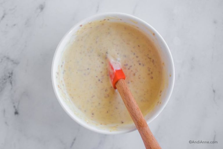 honey mustard dipping sauce in white bowl with spatula