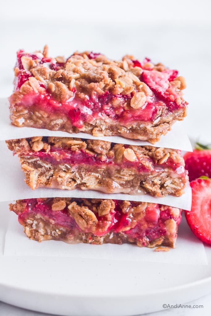 three strawberry oatmeal bars stacked on top of eachother.