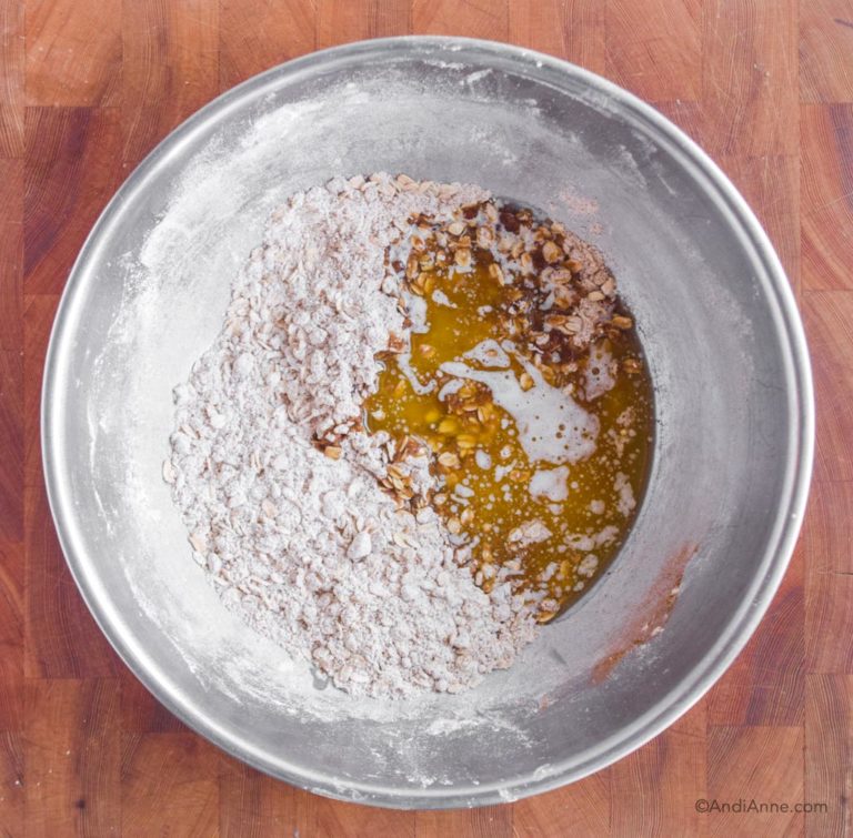 melted butter poured into steel bowl of dried ingredients