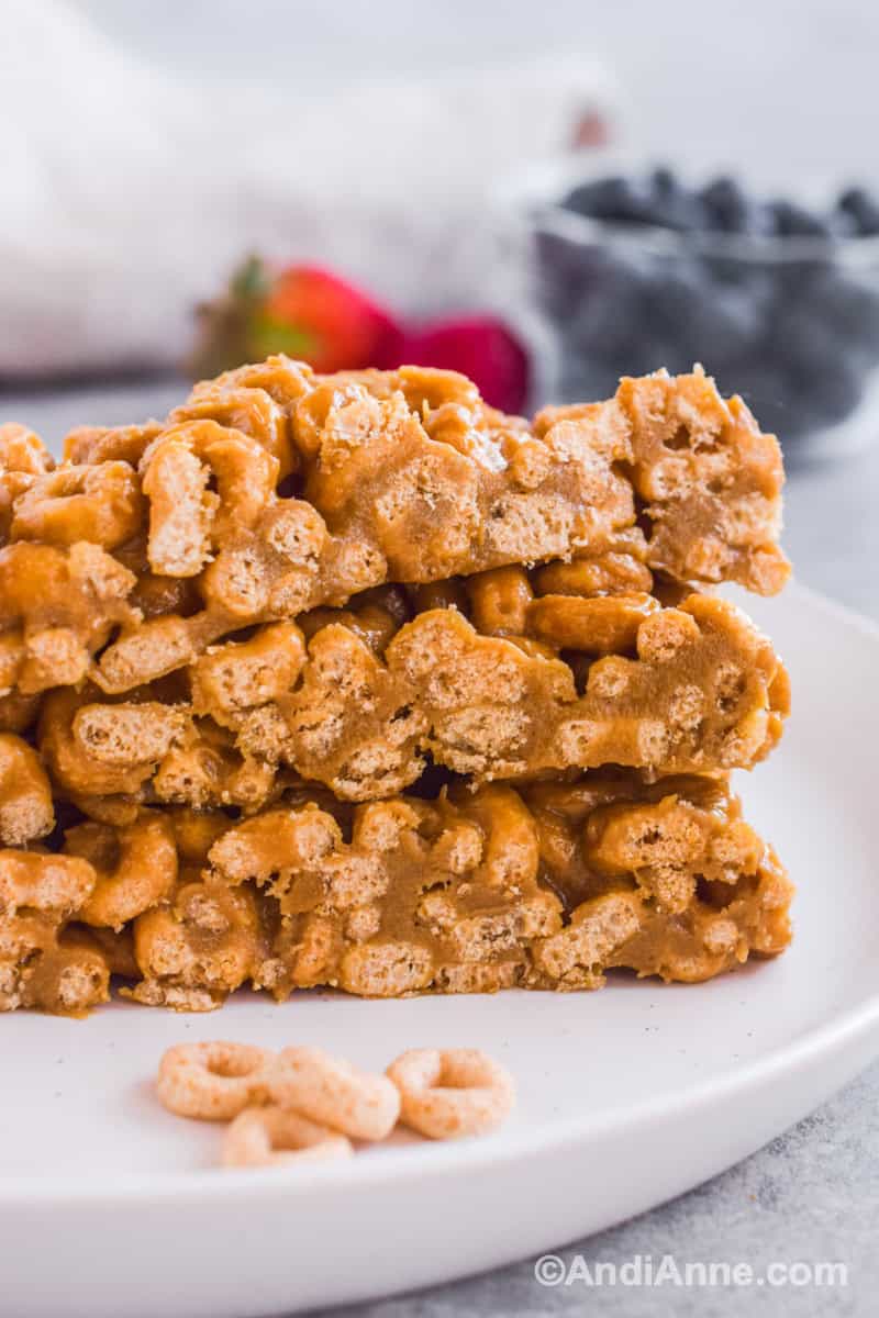Close up of stack of cereal bars on a white plate.
