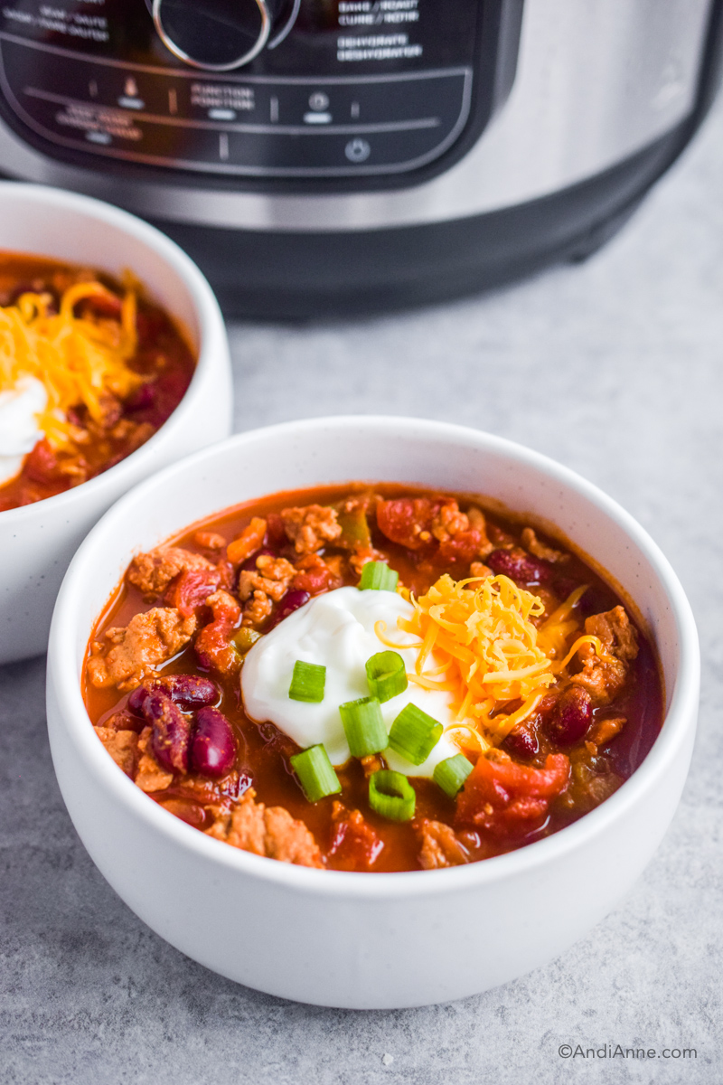 Two bowls of chili with instant pot in background. 