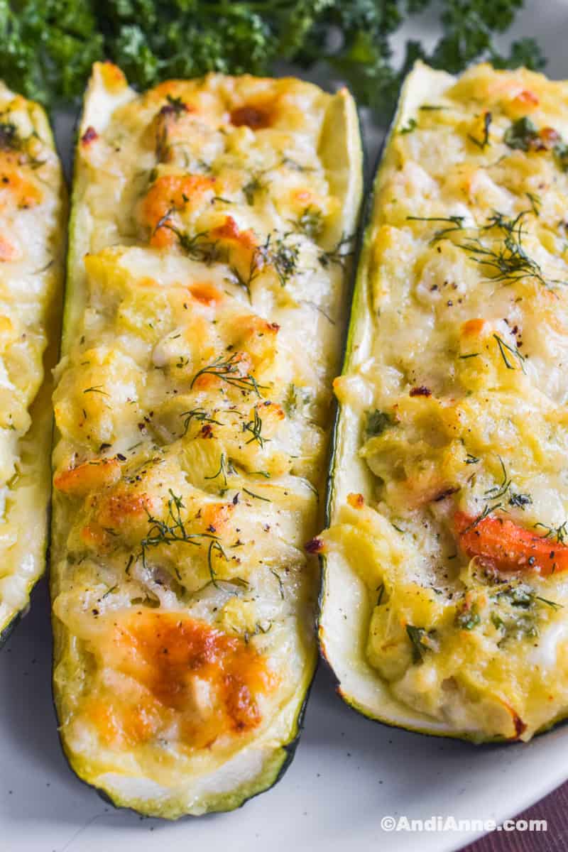 Close up of two zucchini slices stuffed with crab filling.
