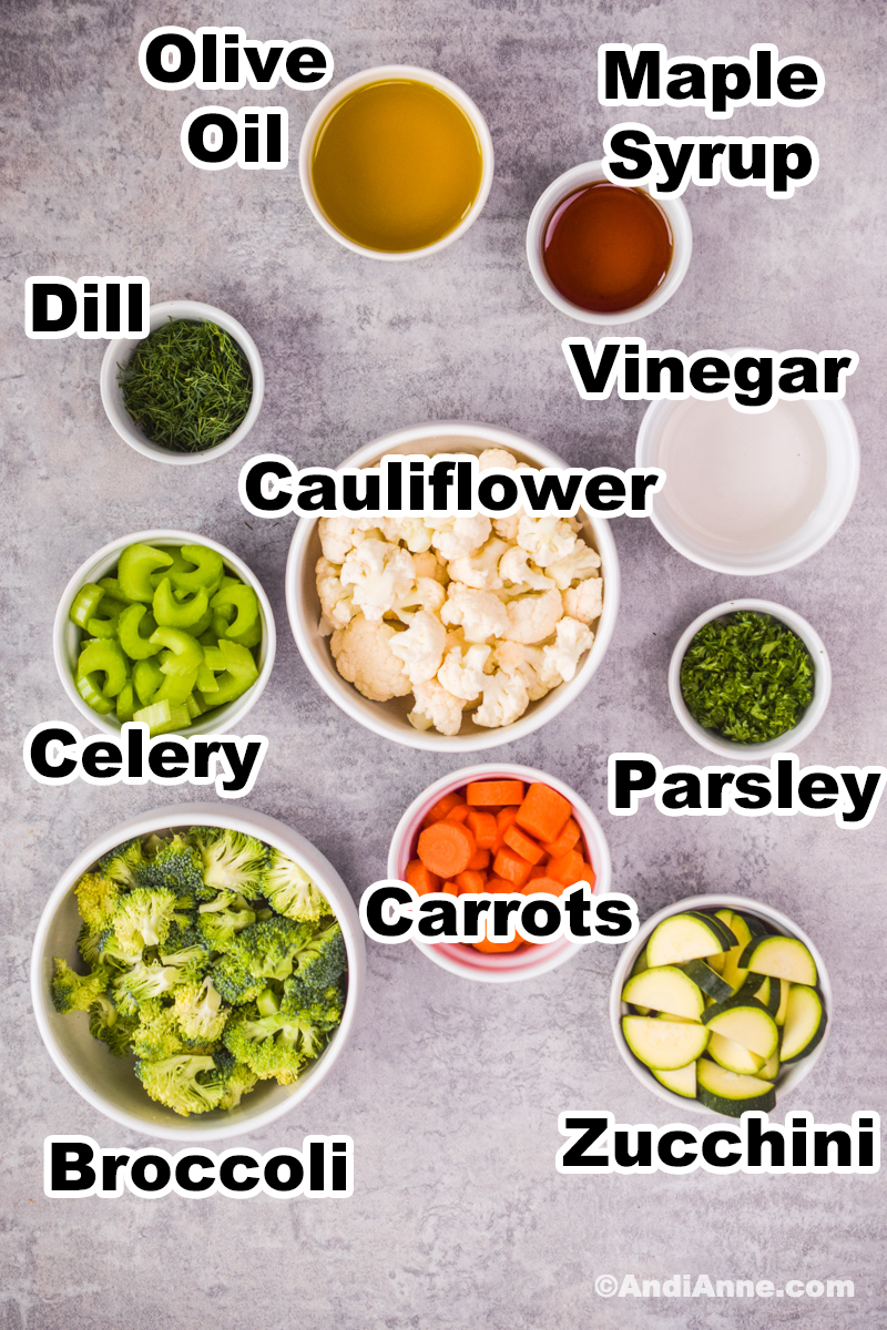Ingredients used to make the recipe including raw vegetables in bowls, vinegar, olive oil, and maple syrup.