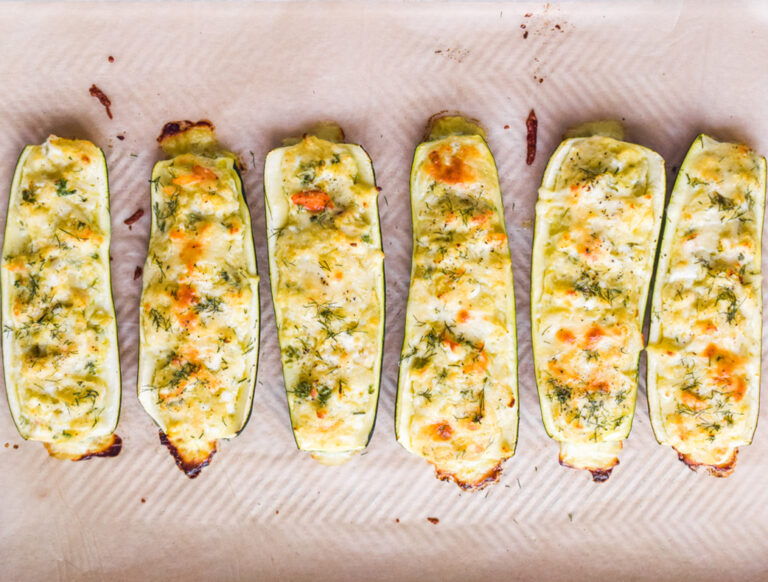 cooked zucchini slices on baking sheet.