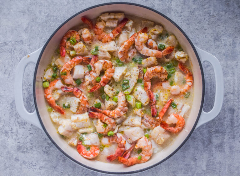 Baked shrimp and cod recipe in round oven dish.