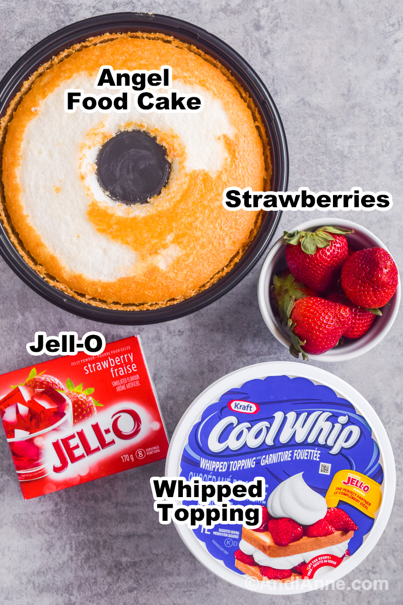 Ingredients to make recipe including pre-made angel food cake, bowl of strawberries, box of jell-o, and container of coolwhip whipped topping.