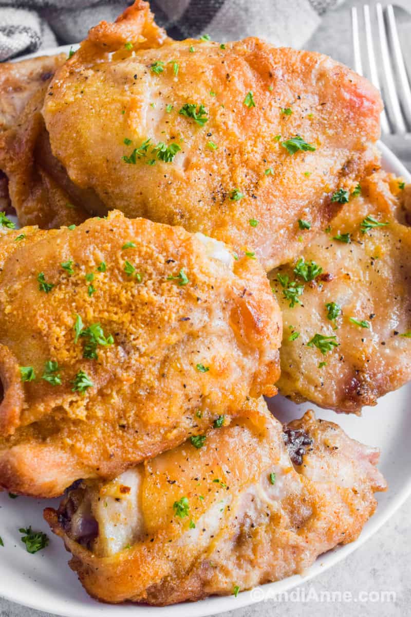Oven fried chicken stacked on top of eachother on a plate.