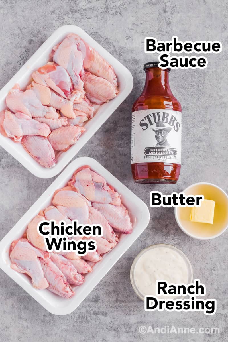Two containers of raw chicken, a jar of barbecue sauce, bowl of butter and ranch dressing on the counter.