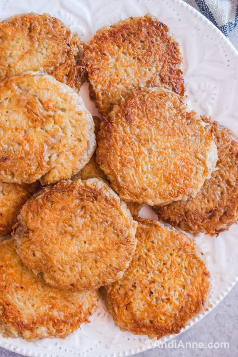 A pile of german potato pancakes on a white plate.