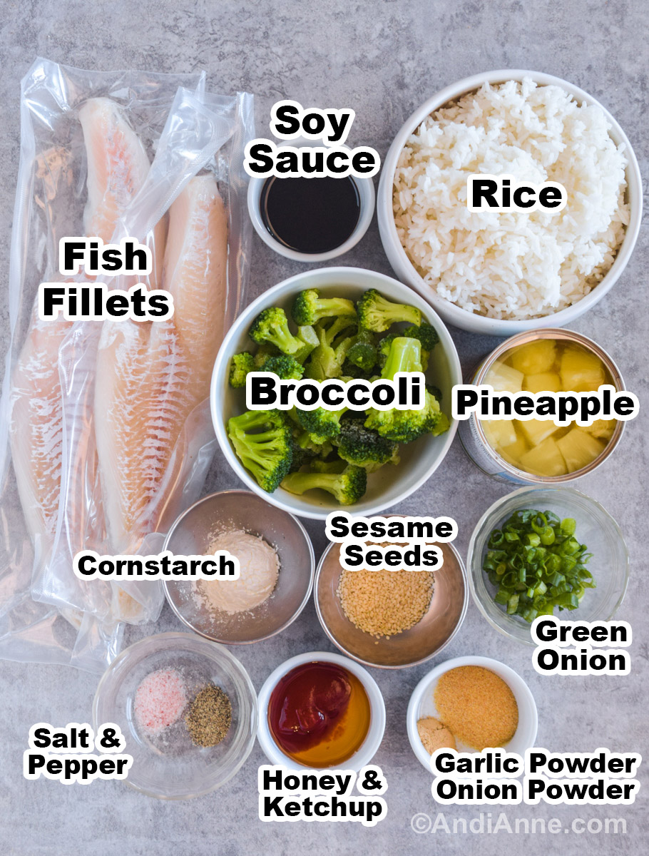 Recipe ingredients including white fish fillets, bowls of cooked white rice, soy sauce, broccoli, pineapple, green onion, honey, ketchup, cornstarch, sesame seeds, garlic powder and onion powder.