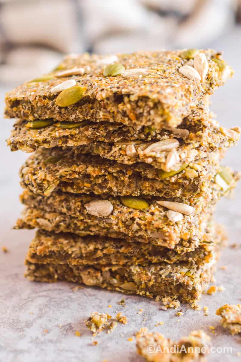 A stack of four seed crackers on top of each other.