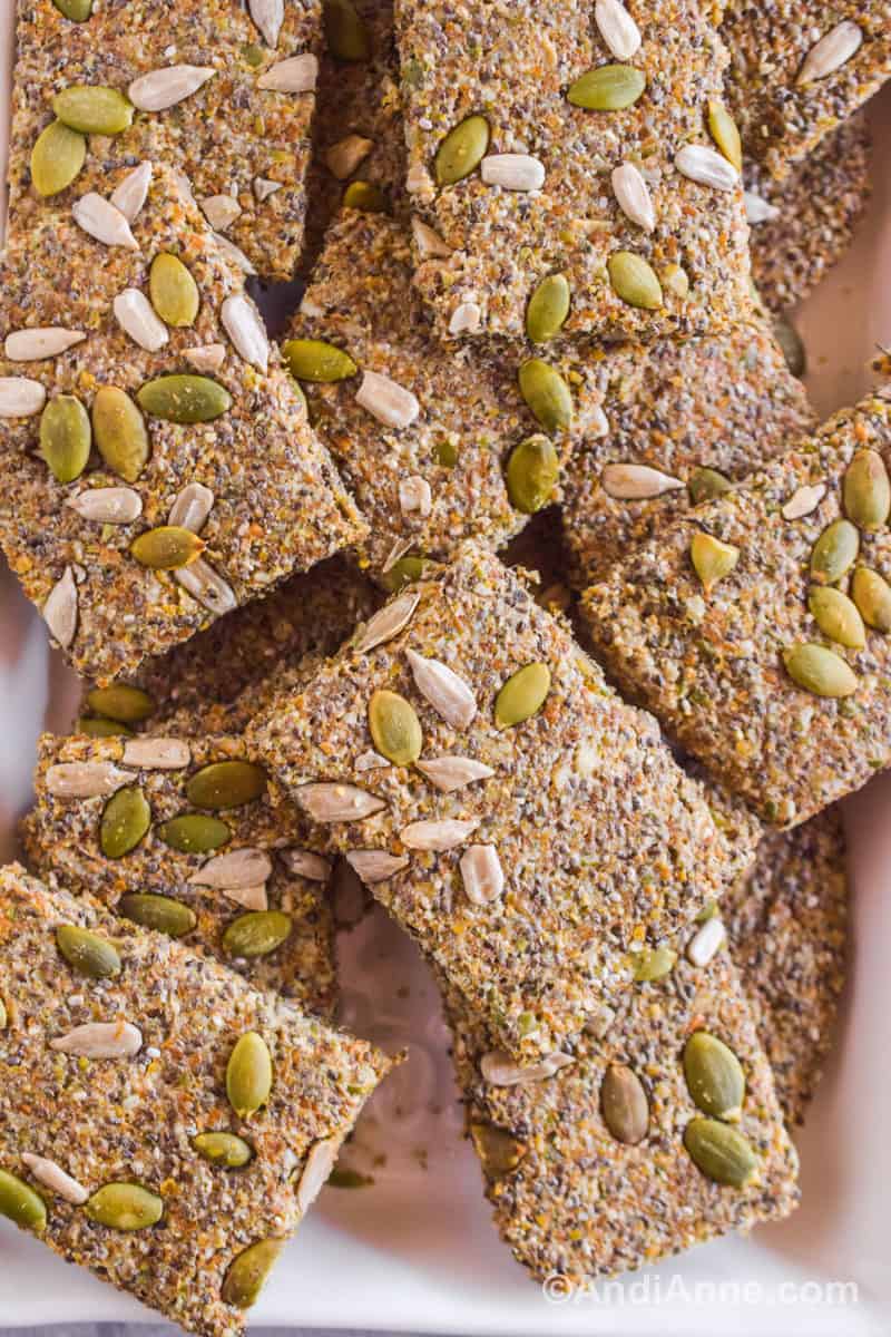 Close up of four seed crackers stacked on top of eachother.