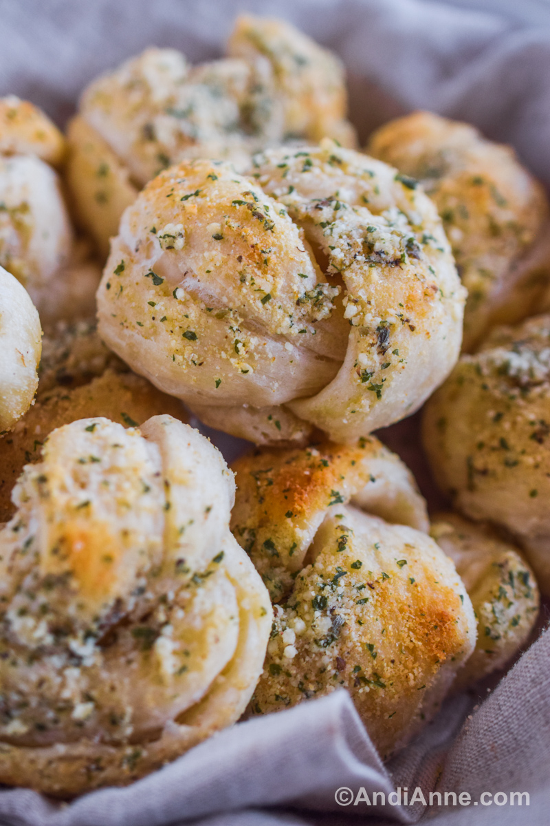 Close up of garlic parmesan knots stacked on top of eachother.