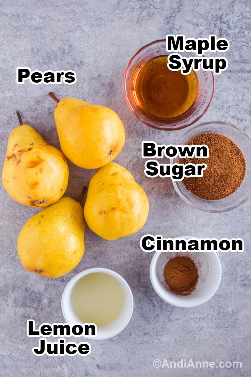 Recipe ingredients on the counter including four pears, bowls of maple syrup, brown sugar, cinnamon, and lemon juice.