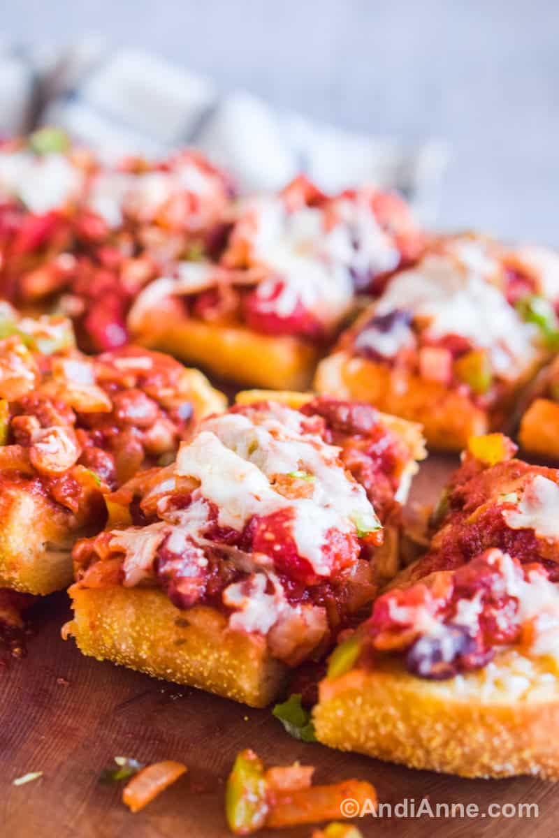 Close up of slices of the garlic bread topped with chili and melted cheese.
