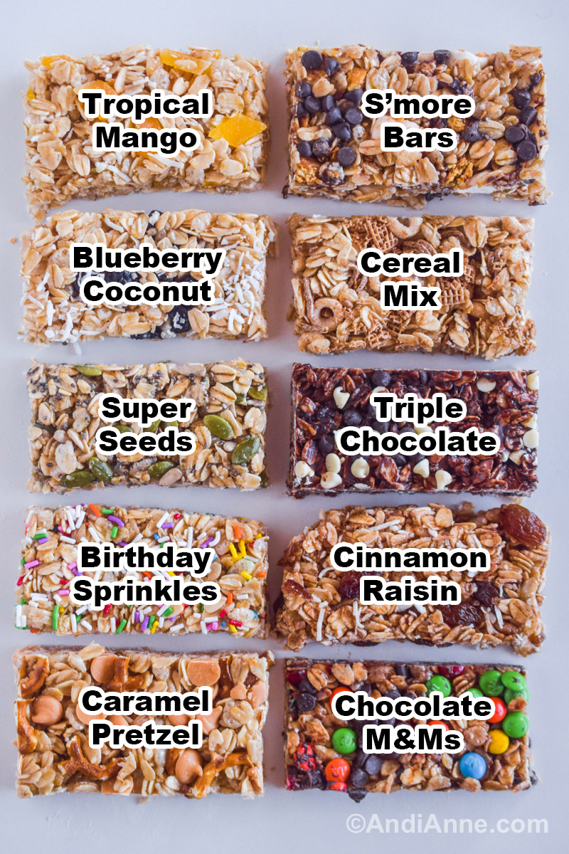 All flavors of granola bars on a counter including tropical mango, s'more bars, blueberry coconut, cereal mix, super seeds, triple chocolate, birthday sprinkles, cinnamon raisin, caramel pretzel, and chocolate M&Ms.