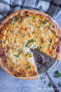 Ground pork quiche with a slice cut out and a fork inside.