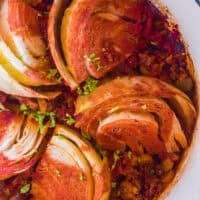 Sweet and sour beef with cabbage in a white pot.